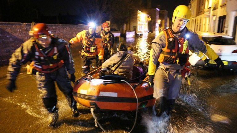 Rescuers taking people to safety in a boat in Boston, Lincs