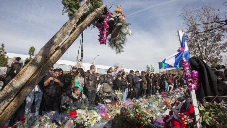 Fans crowd the scene of a memorial rally and car cruise to remember actor Paul Walker and his friend Roger Rodas