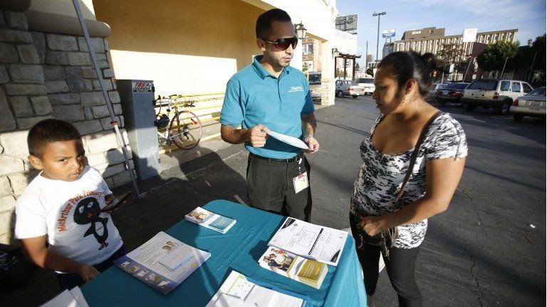 A co-ordinator speaks to a woman during a community outreach on Obamacare in Los Angeles, California. File photo