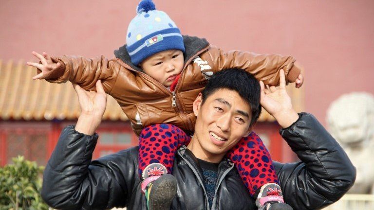 Father and son on visit to Tiananmen Square in Beijing - 5 December