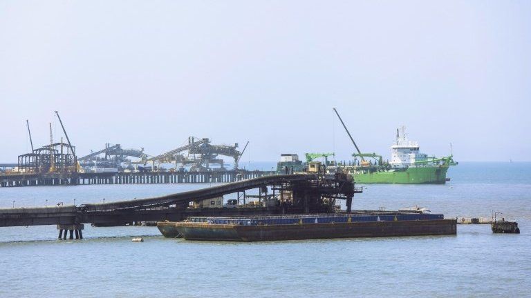 A barge is loaded with coal in the port of Cienaga close to the Caribbean city of Santa Marta on 5 January, 2014