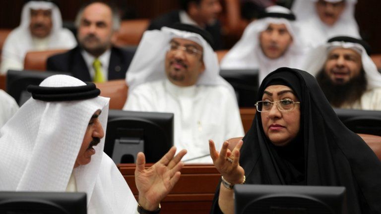 FILE PHOTO: Bahraini lawmaker Latifa Gaould, right, talks with a colleague during a special session of parliament to discuss how to handle the uprising in the Gulf island kingdom, convened in Manama, Bahrain (July 2013)