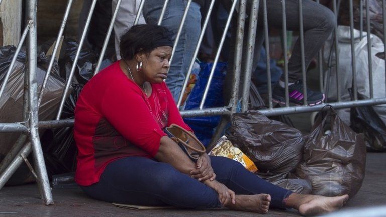 A woman rests at an open air market in Caracas on 16 November, 2013
