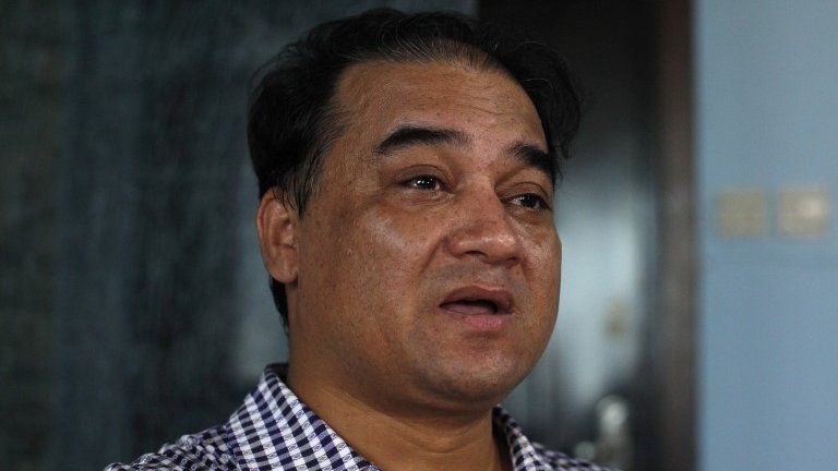Outspoken Uighur scholar and advocate Ilham Tohti speaks during an interview at his home in Beijing on 5 July 2013