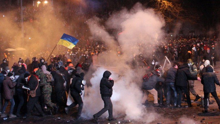 Protesters clash with riot police during an opposition rally in the centre of Kiev