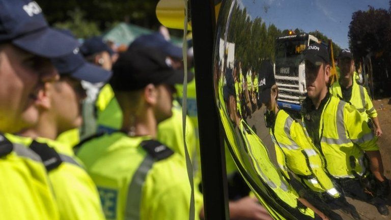 Police escort a lorry arriving in Balcombe in August 2013