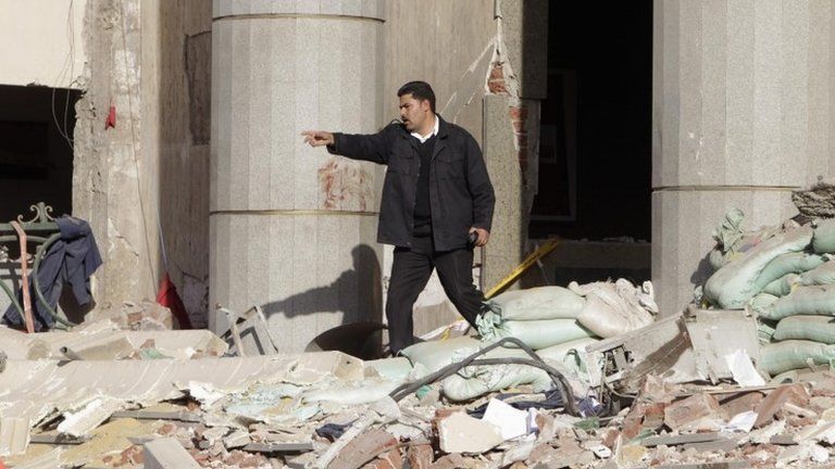 A police officer inspects the site of a bomb attack