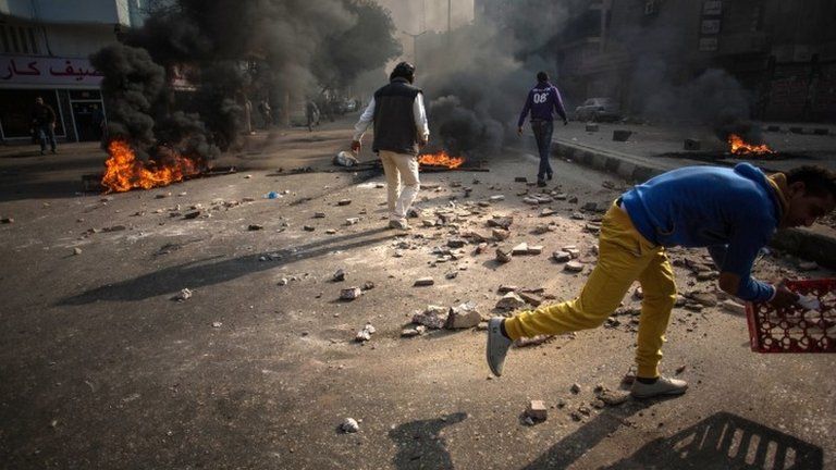 Protesters clash with security forces in the Mohandessin district of Cairo, Egypt, Saturday