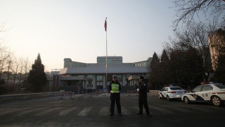 Policemen stand guard outside the Beijing No. 1 Intermediate People's Court, where Xu Zhiyong's trial is held, in Beijing, 26 January 2014