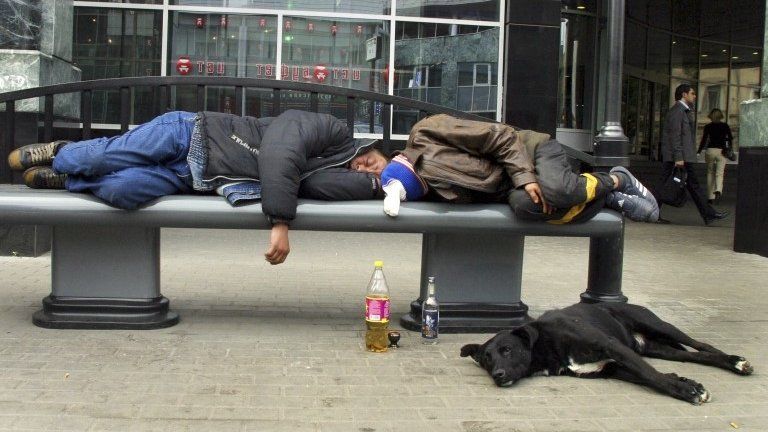 In this Sept. 2005 file photo, men sleep after drinking on a bench in downtown Moscow