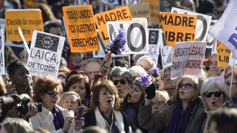 Women hold signs during a protest against a reform of the country's abortion law proposed by the conservative Spanish government, in Madrid on 1 February 2014