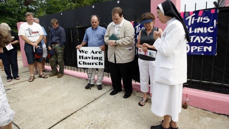 Sister Mary Dorothea Sondgeroth, right, leads abortion opponents in prayer on the sidewalk in front of the Jackson Women's Health Organization Clinic in Jackson, Miss., Wednesda 21 August 2013