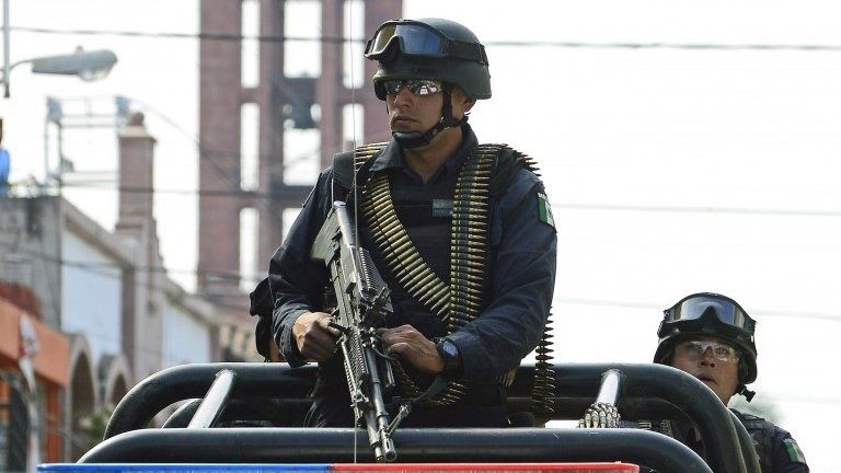 Mexican soldiers patrol the streets of Apatzingan, in Michoacan State on 16 January, 2014