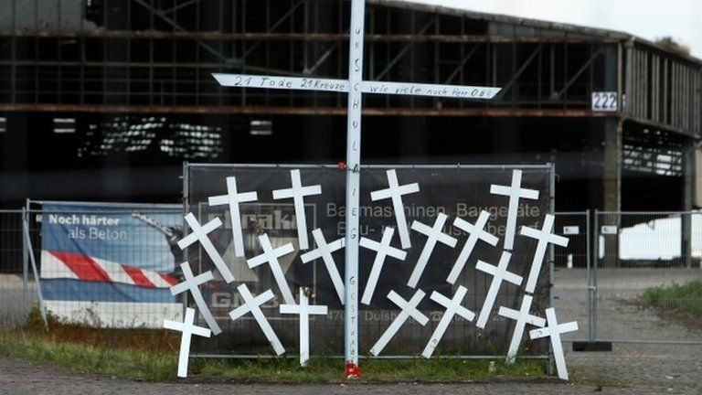 21 crosses are pictured on 6 August at the site where the 21 Love Parade stampede victims died in Duisburg