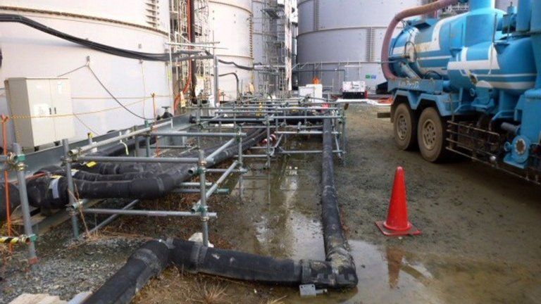 Contaminated water around a tank at Tepco's Fukushima Dai-ichi nuclear power plant at Okuma in Fukushima prefecture, 20 February 2014