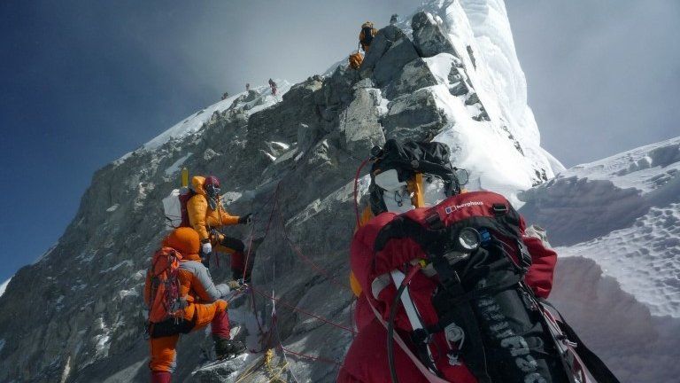 In this May 19, 2009 file photograph, unidentified mountaineers walk past the Hillary Step while pushing for the summit of Mount Everest as they climb the south face from Nepal