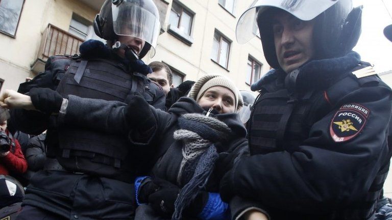 Police arrest a protester in Moscow, 24 February