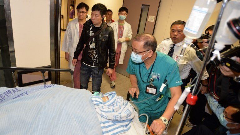 Former Ming Pao chief editor Kevin Lau is taken to an operation room in a hospital in Hong Kong, 26 February 2014