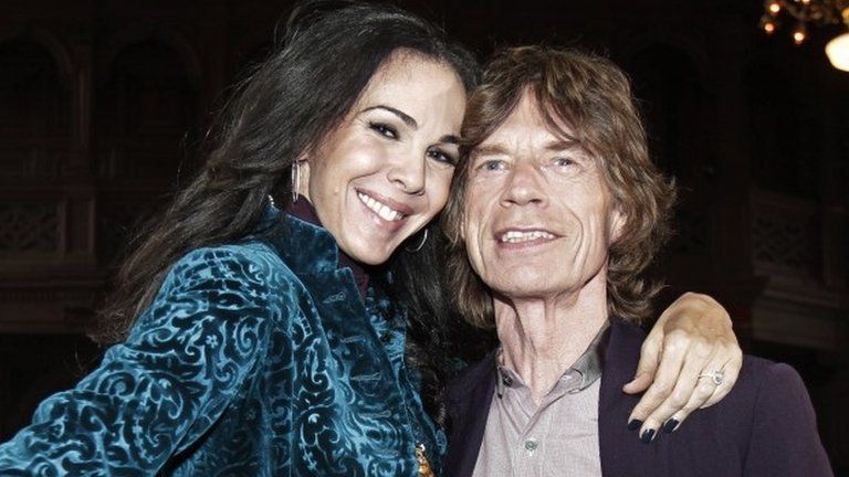 Mick Jagger (right) with designer L'Wren Scott during Fashion Week in New York on 16 February 2012
