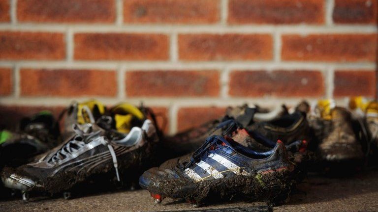 Muddy football boots