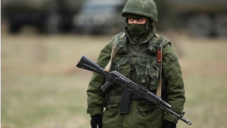 An armed man believed to be a Russian serviceman, outside a Ukrainian military base on 12 March in Simferopol