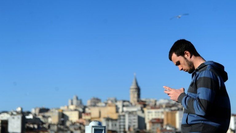 A man looks at his phone in Istanbul, 21 March