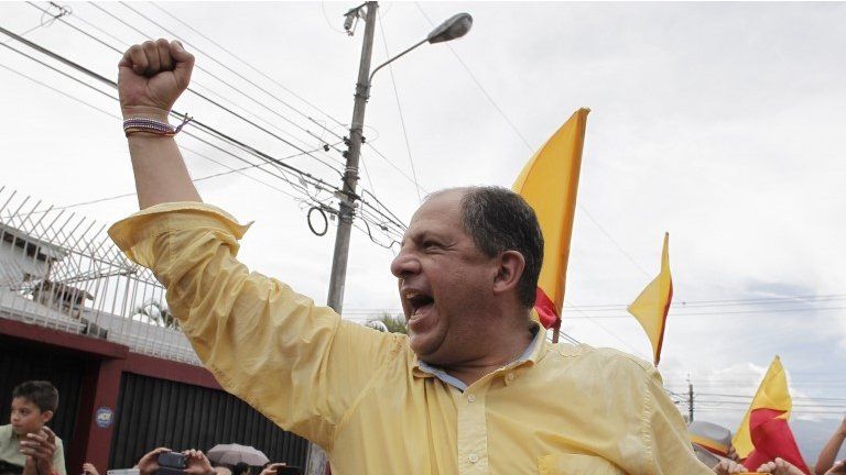 Luis Guillermo Solis gestures to supporters after casting his ballot in San Jose on 6 April, 2014