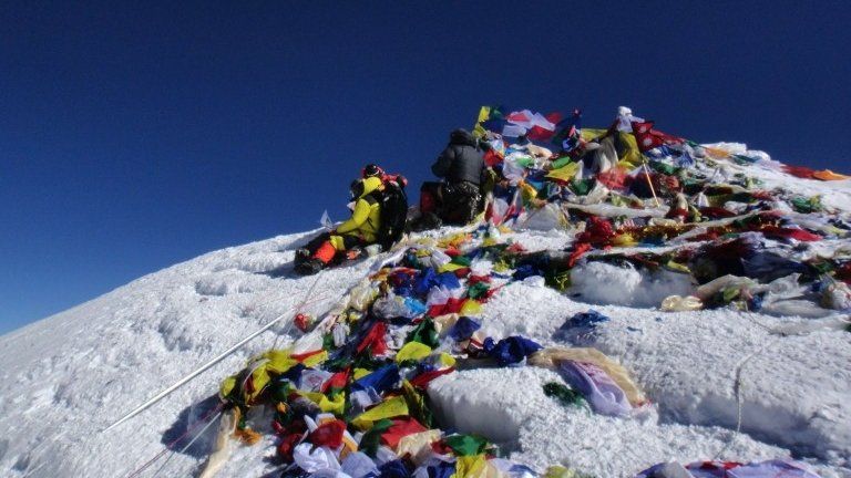 (FILES) In this photograph taken on May 23, 2013, unidentified mountaineers look out from the summit of Mount Everest.