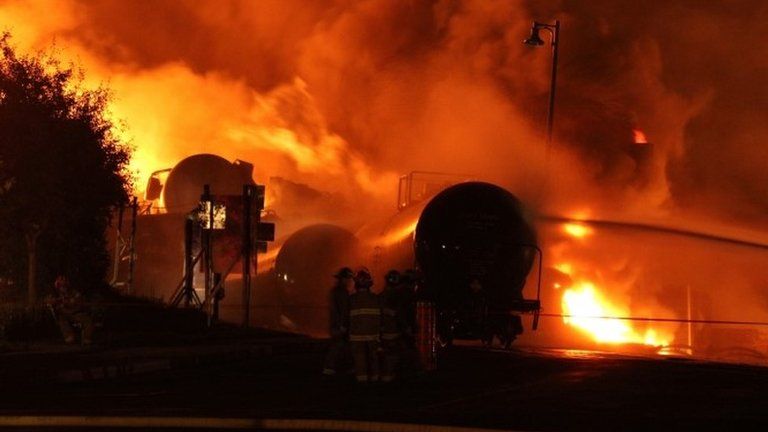 First responders fight burning trains after a train derailment and explosion in Lac-Megantic, Quebec 6 July 2013