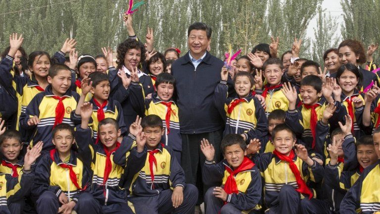 China's President Xi Jinping poses for pictures with primary school students in Shufu county, Xinjiang Uighur Autonomous region, in this picture taken 28 April 2014 by Xinhua News Agency and supplied to Reuters