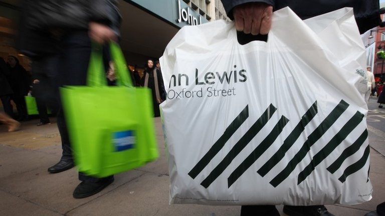 A shopper with a John Lewis bag