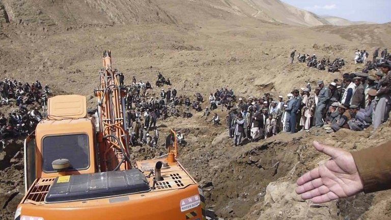 An excavator digs at the site of a landslide at the Hargu district in Badakhshan province, 3 May 2014