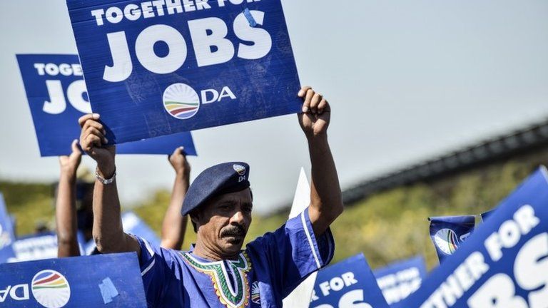 Supporters of South Africa's main opposition party Democratic Alliance (DA) wave placards asking for jobs