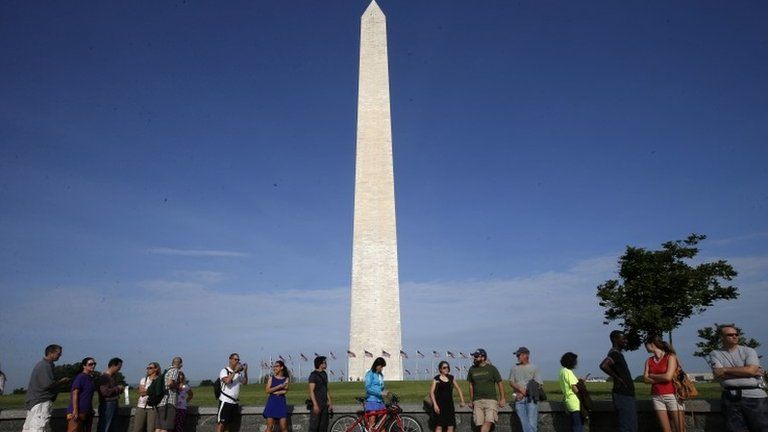 Visitors line up for tickets which are distributed at on a first-come basis at the Washington Monument in Washington, 12 May 2014