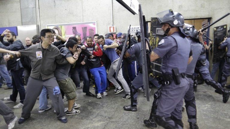 Subway train operators, along with some activists, clash with police at the Ana Rosa metro station on the second day of their metro strike in Sao Paulo, Brazil, 6 June 2014