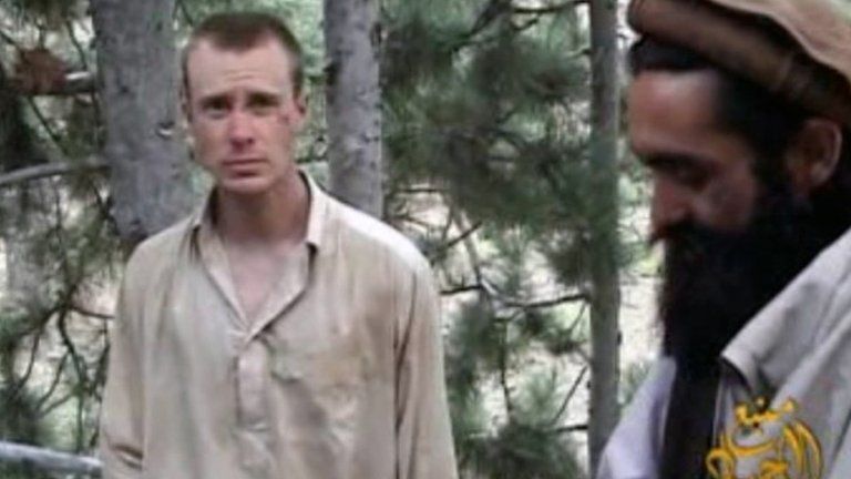 This file image provided by IntelCenter shows a frame grab from a video released by the Taliban containing footage of a man believed to be Bowe Bergdahl, left. 8 December 2010
