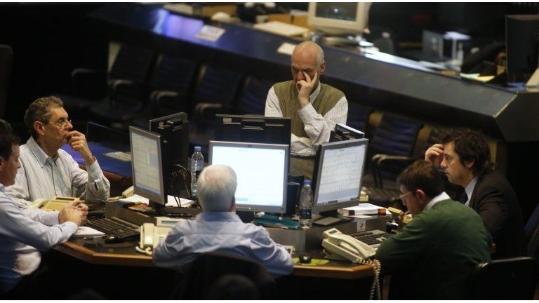 Argentine stockbrokers work on the floor of the Buenos Aires Stock Exchange June 16, 2014.