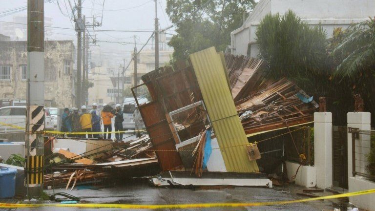 A wooden house which collapsed due to strong winds caused by Typhoon Neoguri is seen in Naha, on Japan's southern island of Okinawa, 8 July 2014