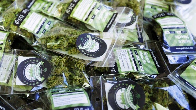 Packets of a variety of recreational marijuana named "Space Needle" are shown during packaging operations at Sea of Green Farms in Seattle 1 July 2014