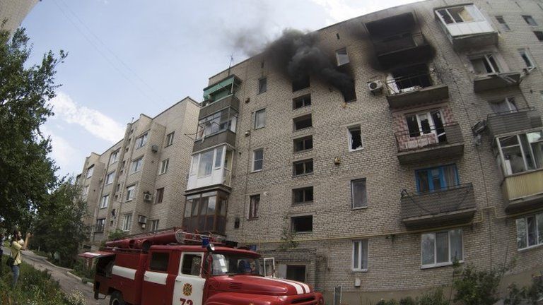 A fire engine outside a damaged block of flats in Marinka, Donetsk, 12 July