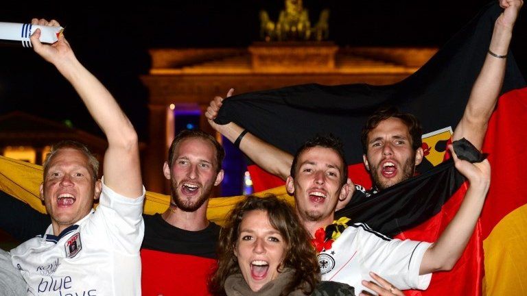 German fans celebrate in front of the Brandenburg Gate in Berlin, 13 July 2014