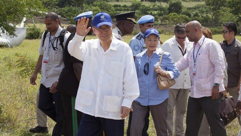 UN Secretary General Ban Ki-moon arrives with his wife Yoo Soon-taek and Haitian Prime Minister Laurent Lamothe during a visit to the village of Los Palmas on 14 July, 2014