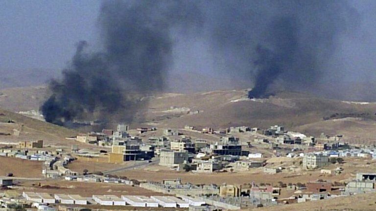 Smoke billows from the Lebanese border town of Arsal, 2 August