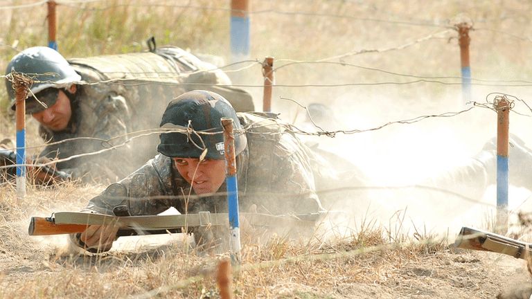 Armenian soldiers from Nagorno-Karabakh crawl through an obstacle course, 25 October 2012