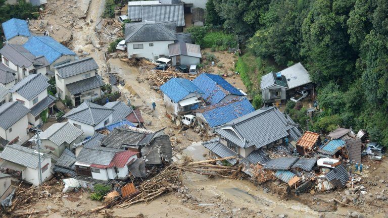 Houses heavily damaged after a massive landslide swept through residential areas in Hiroshima, western Japan, on 20 August 2014