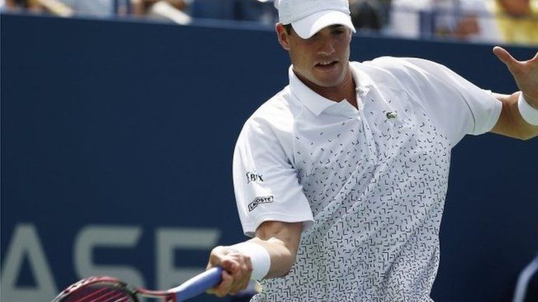 John Isner of the US hits a return to Marcos Giron