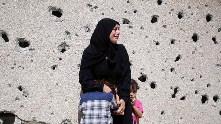 Palestinians mourn two teenaged brothers killed in Israeli air strikes in Gaza on 26 August 2014