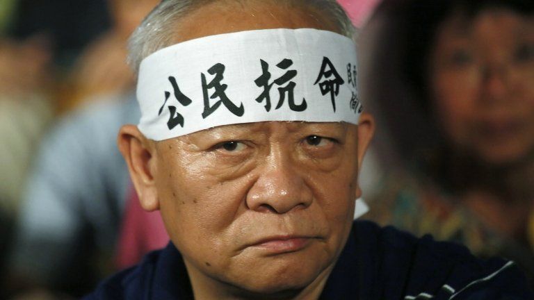 A protester wears a headband with Chinese characters "Citizen disobedience" during a rally after China's legislature ruled out allowing open nominations in inaugural elections for Hong Kong's leader in Hong Kong on 31 August 2014