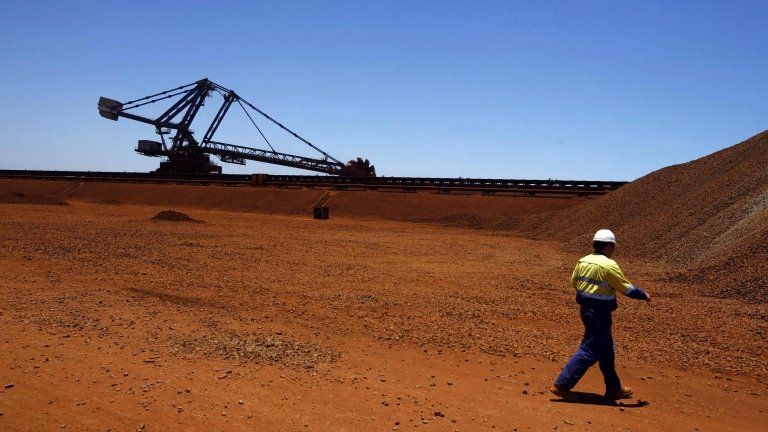 A worker at the Fortescue loading dock located at Port Hedland in the Pilbara region of Western Australia in this 3 December 2013 file photo