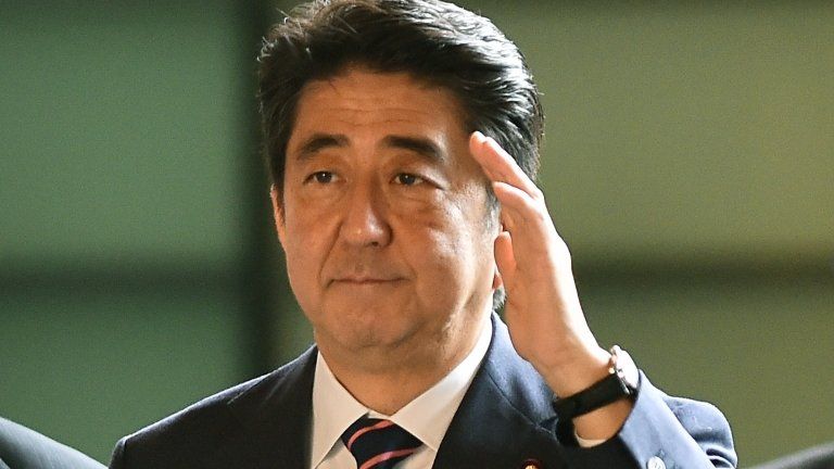 Japanese Prime Minister Shinzo Abe (C) arrives at his official residence in Tokyo on 3 September 2014